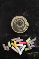 a pile of colored chalk sticks on a black table photo