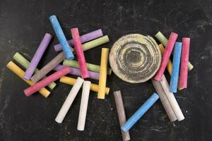 a pile of colorful chalk sticks on a black background photo