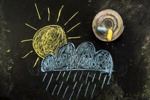 a chalk drawing of a cloud and snow on a blackboard photo