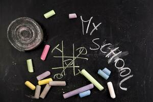 chalk and crayons on a blackboard stock photo