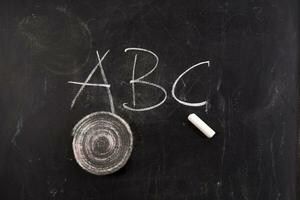 chalk and crayons on a blackboard stock photo