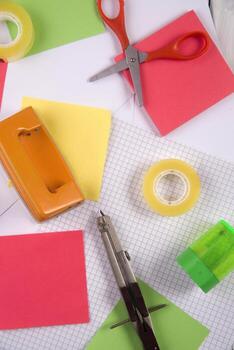 a table with a bunch of different colored paper photo
