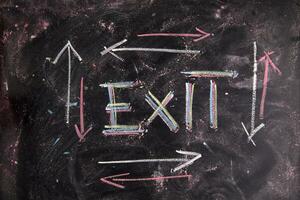 exit sign on blackboard with arrows photo