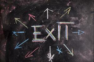 exit sign on blackboard with arrows photo