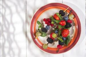 Skewer of berries in pot photo