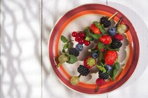 Skewer of berries in pot photo