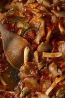 a pan with a spoon in it and some food photo