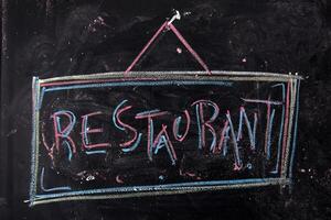 a chalkboard with the word restaurant written on it photo