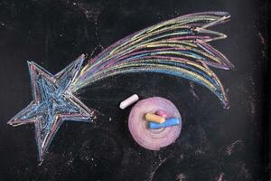 a chalk drawing of a star on a blackboard photo