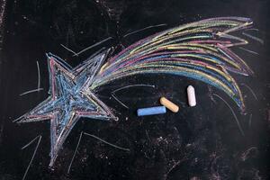 a chalk drawing of a star with colorful crayons photo