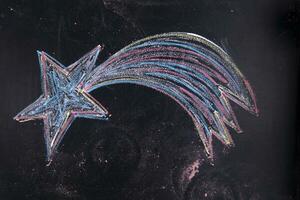 a chalk drawing of a star on a blackboard photo