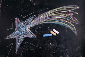 a chalk drawing of a star on a blackboard photo