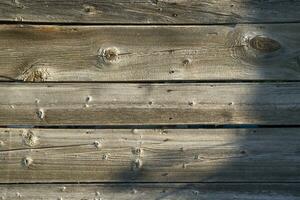 a close up of a wooden wall with a red fire hydrant photo