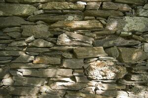 a stone wall with many different types of rocks photo