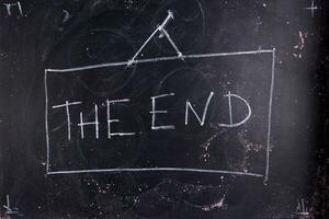 the end written on a chalkboard with chalk photo