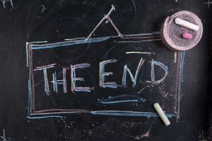 the end written on a chalkboard with chalk photo