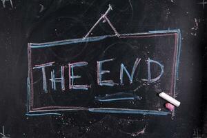 the end written on a chalkboard with chalk photo