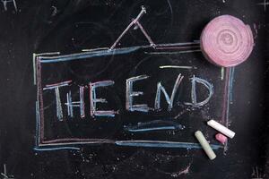 the end written on a chalkboard with chalk photo