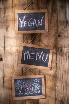 a chalkboard with the words vegan menu and vegan menu written on it photo
