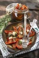 Dried tomatoes and rosemary photo