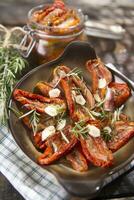 Dried tomatoes and rosemary photo