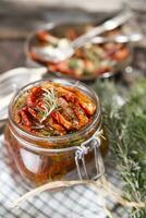 Dried tomatoes and rosemary photo