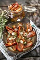 Dried tomatoes and rosemary photo