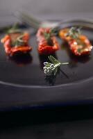 Dried tomatoes with rosemary photo