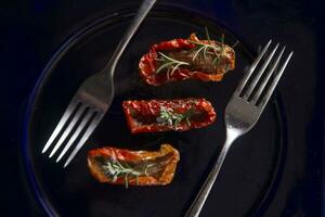 Dried tomatoes with rosemary photo