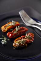 Dried tomatoes with rosemary photo
