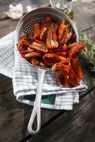 Dried tomatoes with rosemary photo