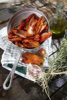 Dried tomatoes with rosemary photo