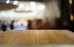 Empty dark wooden table in front of abstract blurred bokeh background of restaurant . can be used for display or montage your products.Mock up for space. photo