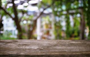 image of wooden table in front of abstract blurred background of outdoor garden lights. can be used for display or montage your products.Mock up for display of product. photo