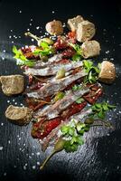 Anchovies tomatoes and capers photo