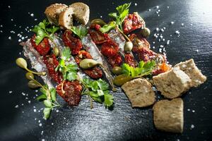 Anchovies tomatoes and capers photo