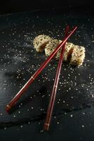 Sushi dish with chopsticks photo