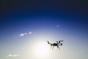 Drone in flight with cloudy sky photo