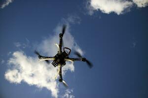 Drone in flight with cloudy sky photo