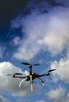 Drone in flight with cloudy sky photo