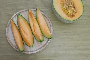 frutas para cuidado de la salud verde melón de madera mesa miel melón o Cantalupo foto