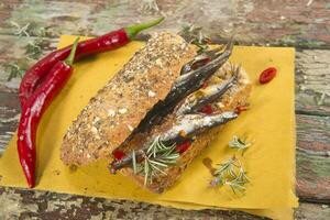 a sandwich with peppers and herbs on a napkin photo