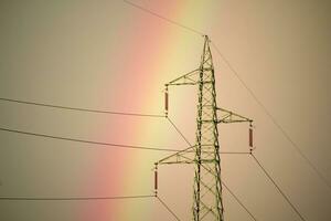 High tension and rainbow pylons photo