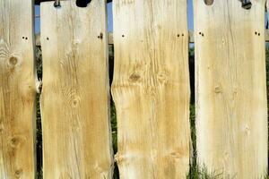 Fence made of wooden planks photo