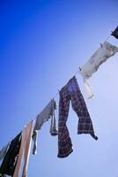 Laundry hanging out in the sun photo