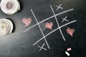 Tic-tac-toe game with heart as a symbol photo