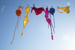 Swimwear of various colors lying in the sun photo