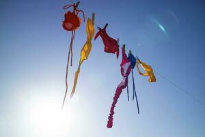 Swimwear of various colors lying in the sun photo