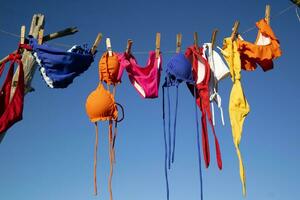 Female swimwear hanging in the sun to dry photo