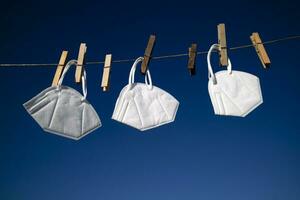 Coronavirus protection masks hung out to dry photo